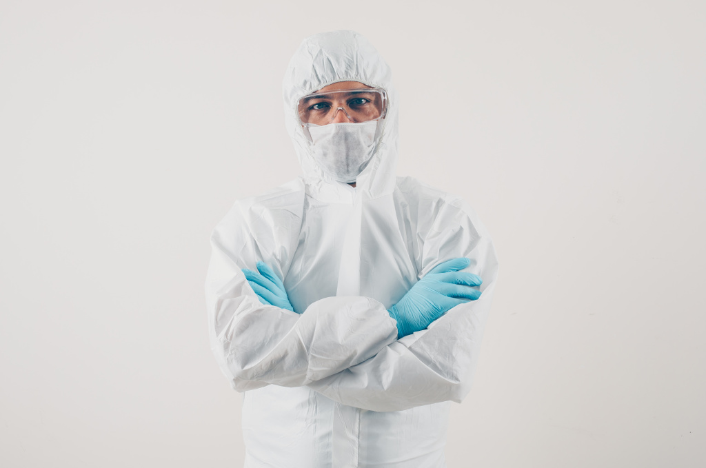 portrait-of-a-doctor-at-light-background-standing-and-looking-in-mask-medical-gloves-and-protective-suit.jpg