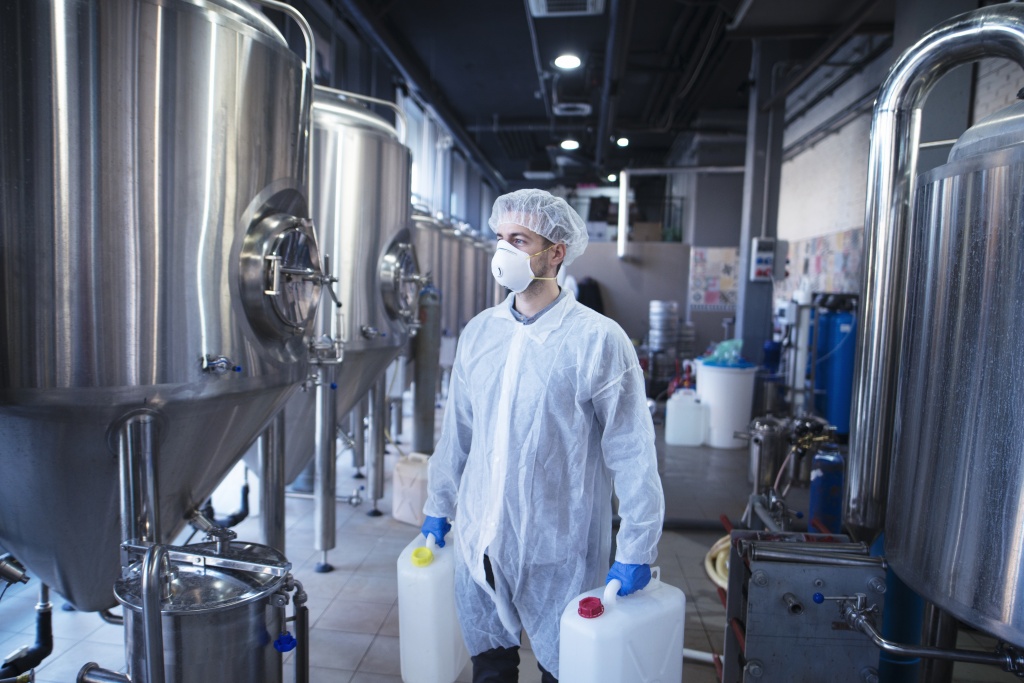 technologist-industrial-worker-holding-plastic-canisters-about-to-change-chemicals-in-the-food-processing-machine.jpg
